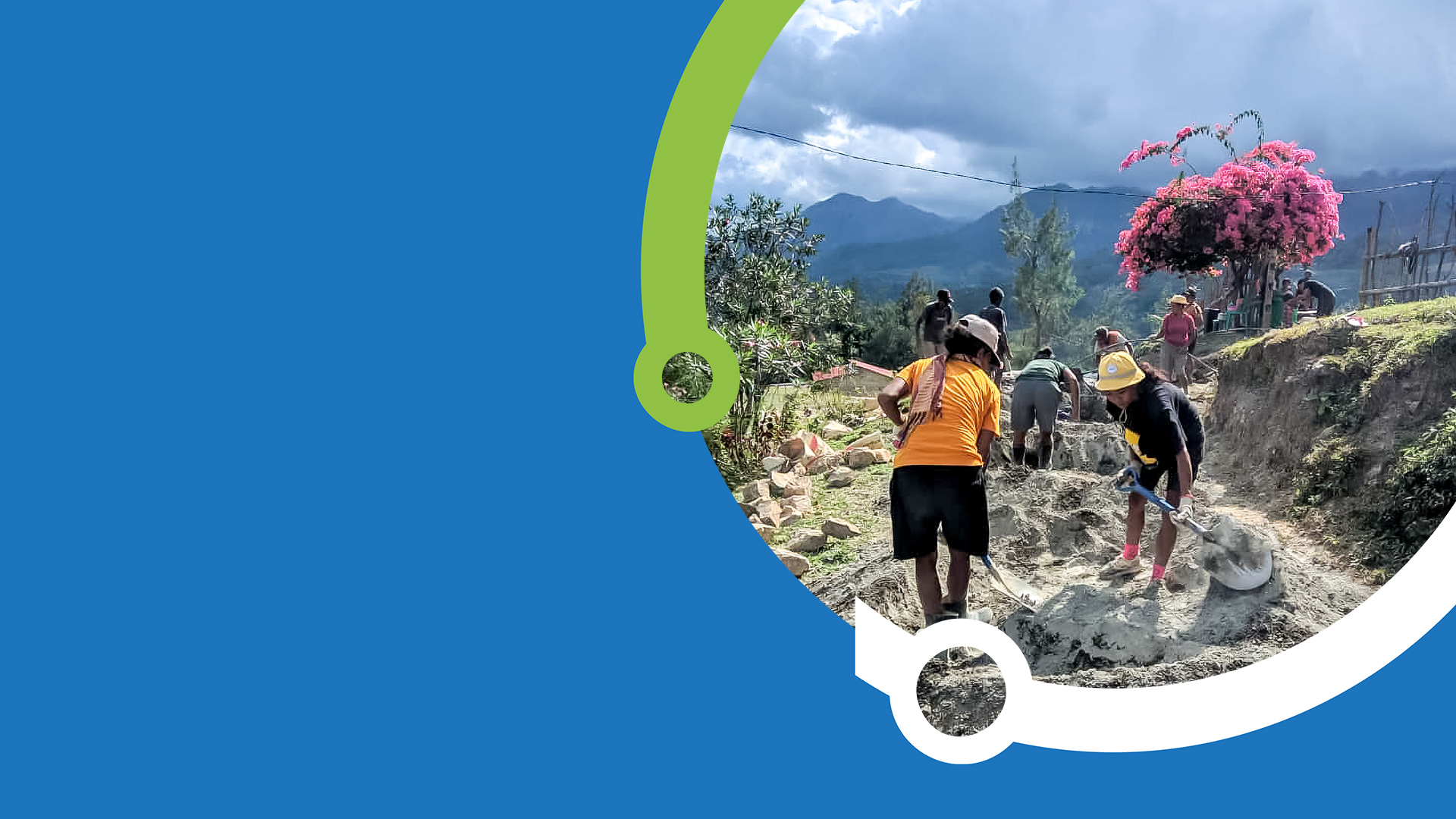 A PARTISIPA branded blue and green frame encircles a picture of a two women and other community members in the background as they dig with shovels amongst mounds of dirt to support road building in a village. A tree with pink flowers, mountains and dark rain clouds can be seen in the distance. 